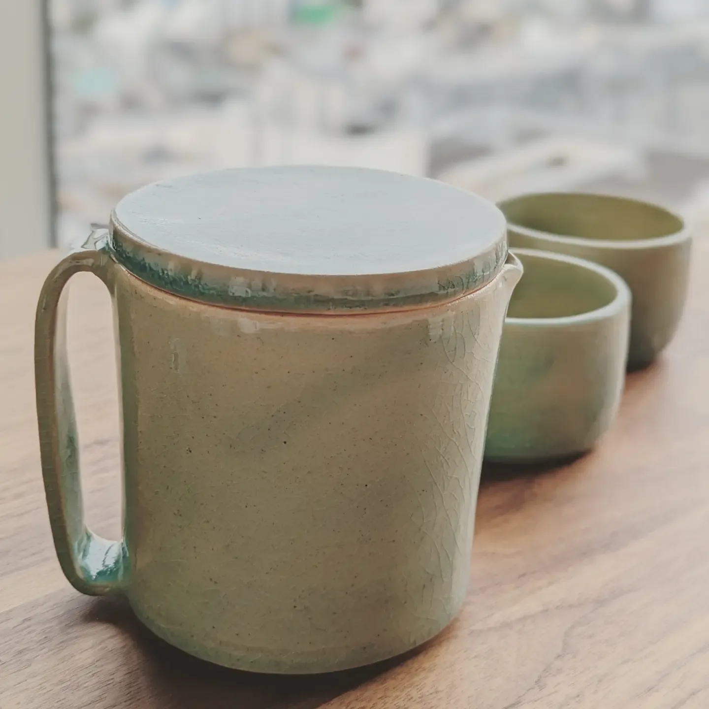 Mug and cups in a sage green glaze